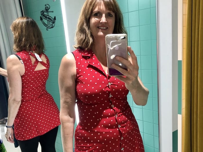 Jane wearing red polka dot top with pretty straps at Beyond Retro Vintage shop in Bristol