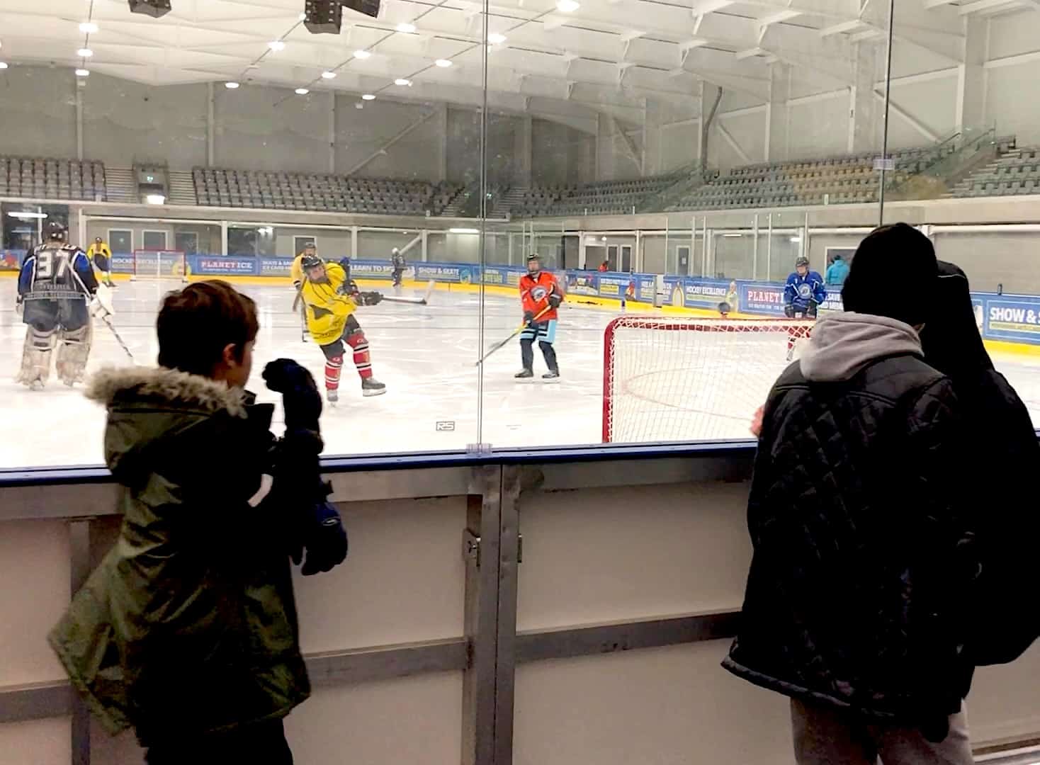 Spectators watching ice hockey practice at Bristol's Planet Ice, home of the Bristol Pitbulls team.