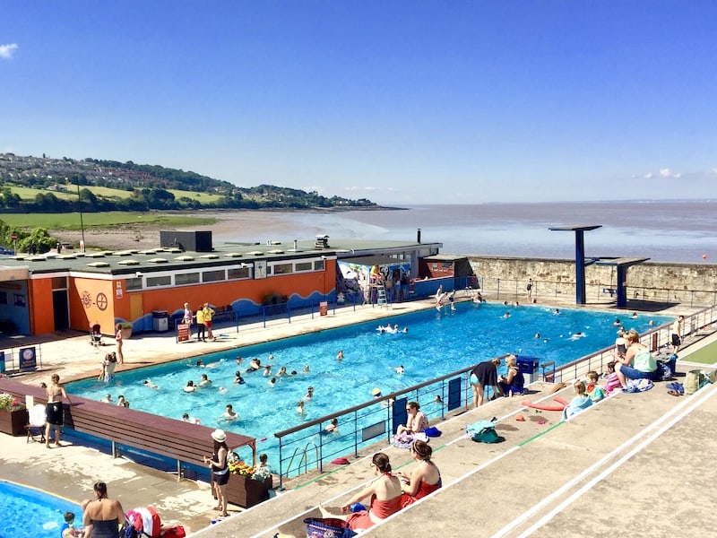Portishead open air pool North Somerset on a busy summer's day. Views of The Bristol Channel and Portishead beach beyond. 