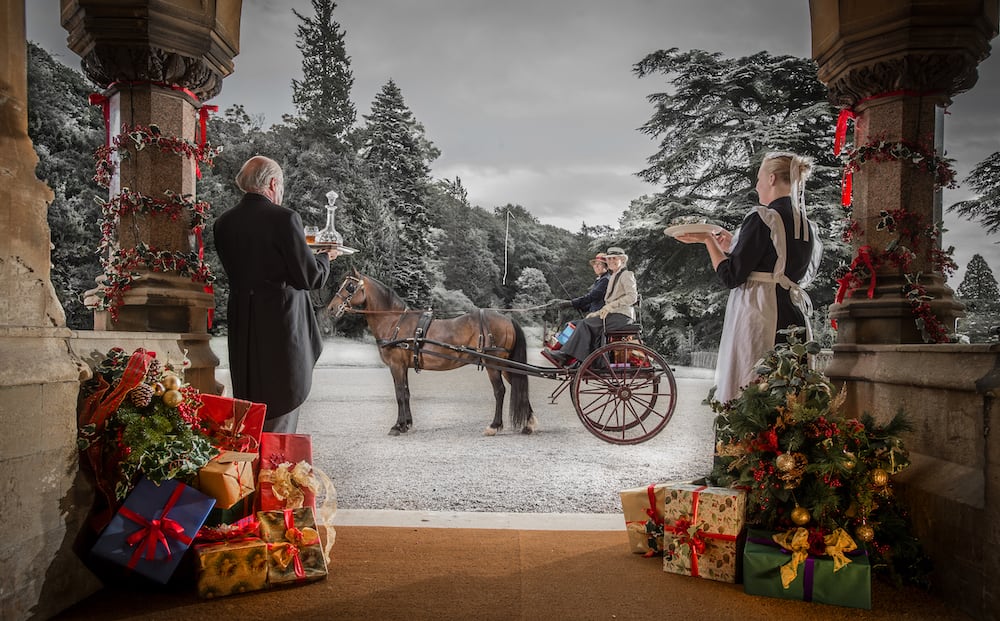 Tyntesfield House at Christmas with a horse and carriage outside in the snow.