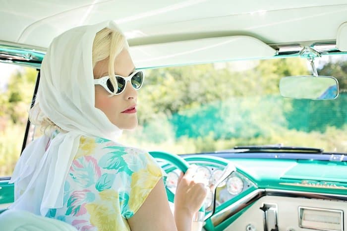 Glamorous lady driving in fifties fashion